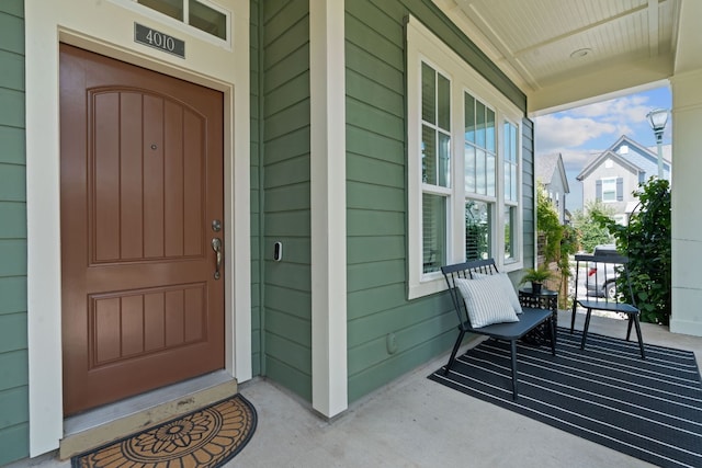 view of exterior entry with a porch