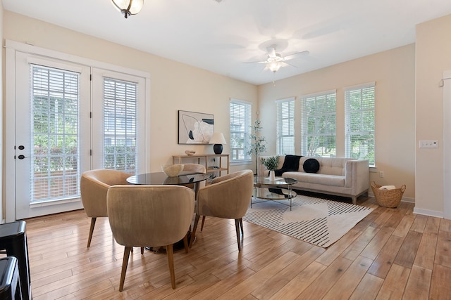 dining room with ceiling fan and light wood-type flooring