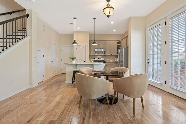 dining area featuring light hardwood / wood-style flooring and a healthy amount of sunlight