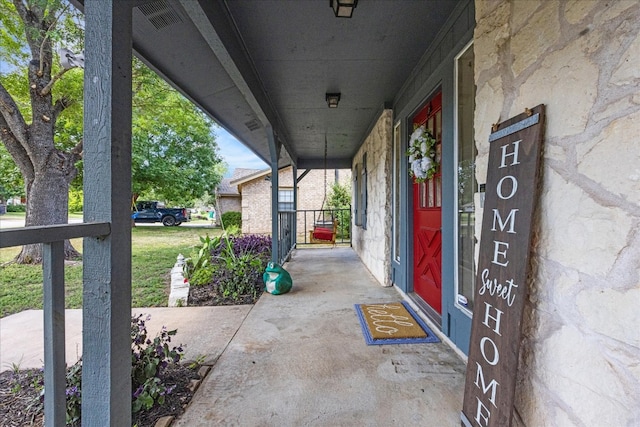 view of exterior entry featuring covered porch