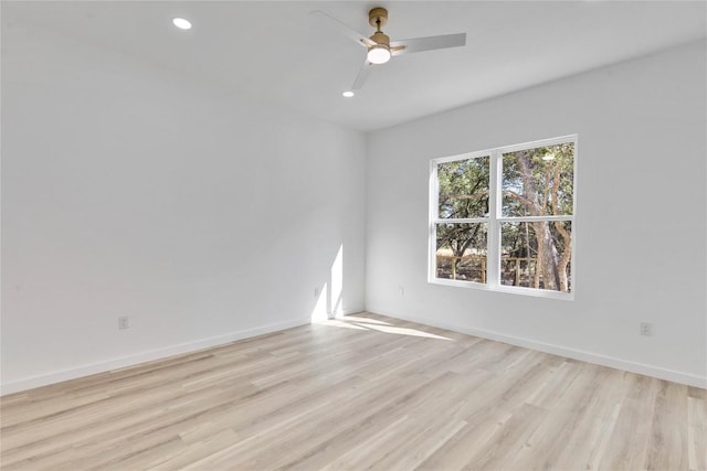 spare room with light hardwood / wood-style floors and ceiling fan