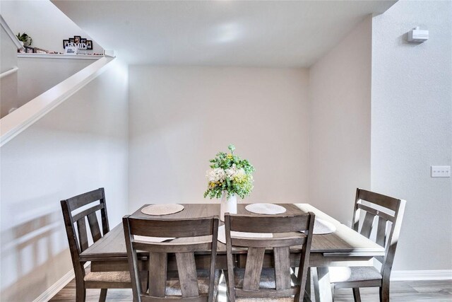 dining area with hardwood / wood-style floors