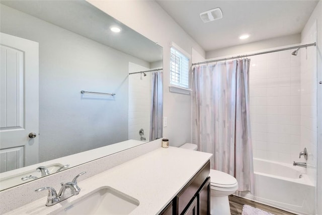 full bathroom featuring shower / bathtub combination with curtain, wood-type flooring, toilet, and vanity