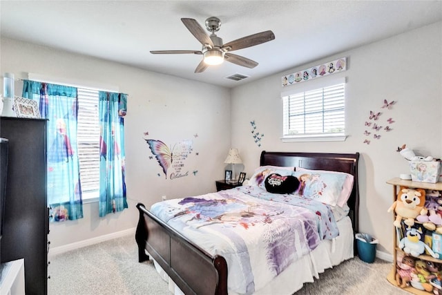 carpeted bedroom with multiple windows and ceiling fan