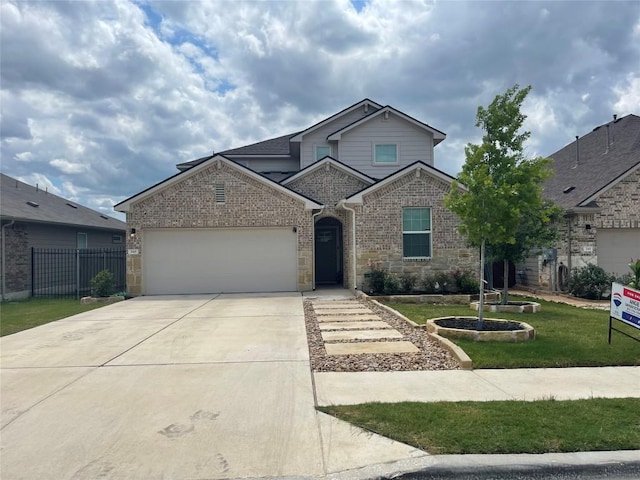 348 Empress Tree Dr, Leander, TX 78641 - traditional home with an attached garage, concrete driveway, brick siding, and stone siding
