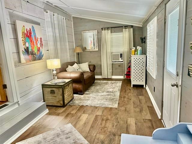 sitting room featuring vaulted ceiling and hardwood / wood-style flooring