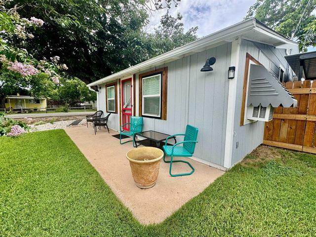 back of house featuring a yard and a patio area