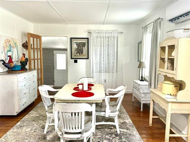 dining space with a wall mounted AC and dark wood-type flooring