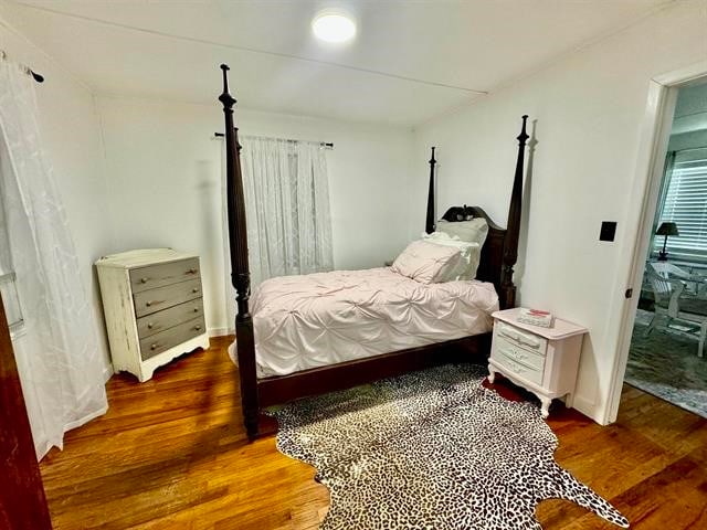 bedroom with dark hardwood / wood-style flooring