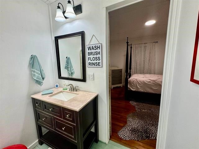 bathroom with vanity and wood-type flooring