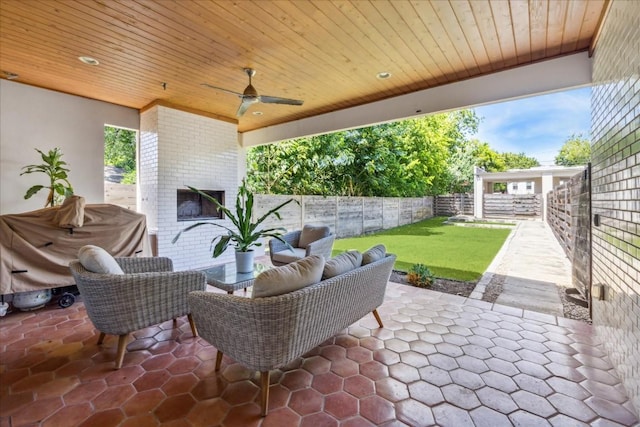 view of patio featuring an outdoor living space with a fireplace and ceiling fan