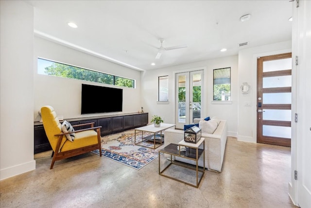 living room featuring french doors, ceiling fan, and plenty of natural light