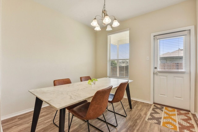 dining area featuring a notable chandelier and light hardwood / wood-style flooring