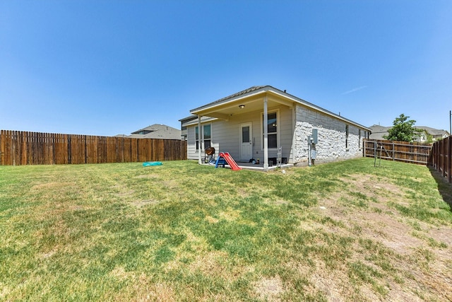 rear view of house with a lawn