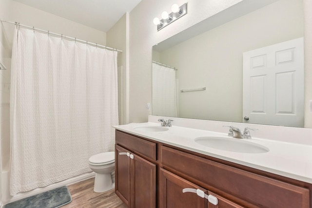 full bathroom with toilet, wood-type flooring, vanity, and shower / bathtub combination with curtain