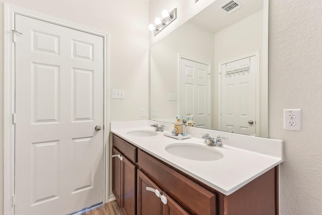 bathroom with hardwood / wood-style floors and vanity