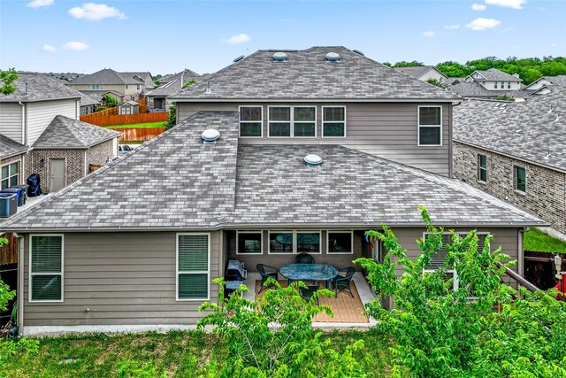 rear view of house featuring a deck