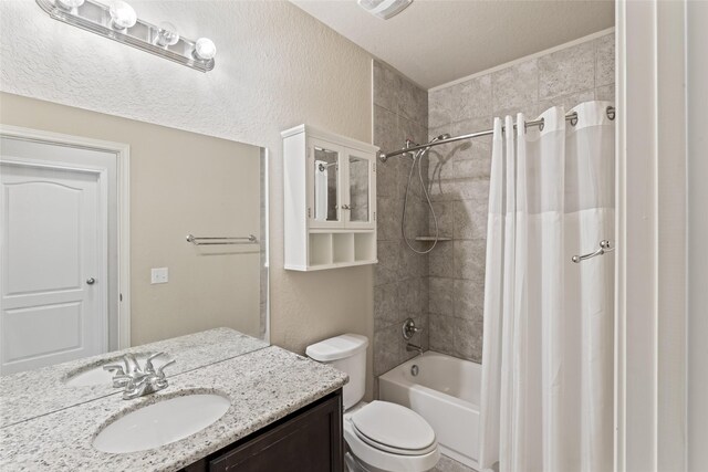 full bathroom featuring shower / tub combo, toilet, vanity, and a textured ceiling