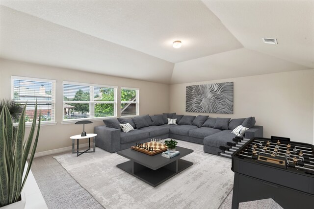 living room featuring lofted ceiling