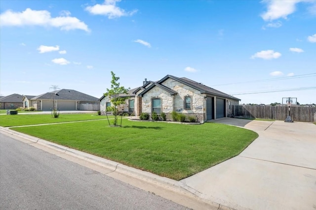 view of front of house with stone siding, fence, driveway, and a front lawn