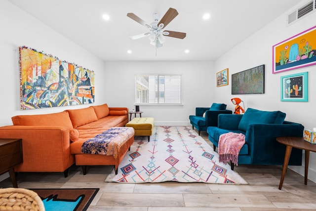 living room with ceiling fan and hardwood / wood-style floors