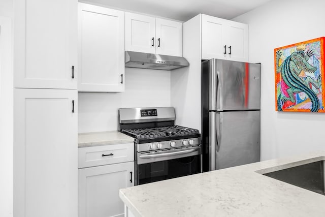 kitchen with sink, stainless steel appliances, light stone countertops, and white cabinets