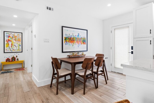 dining space featuring light wood-type flooring