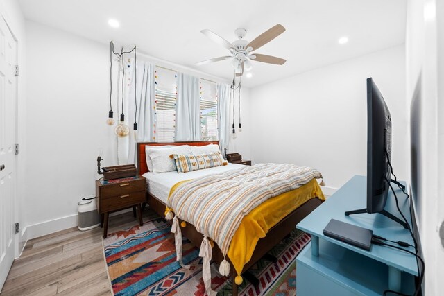 bedroom with light hardwood / wood-style floors and ceiling fan