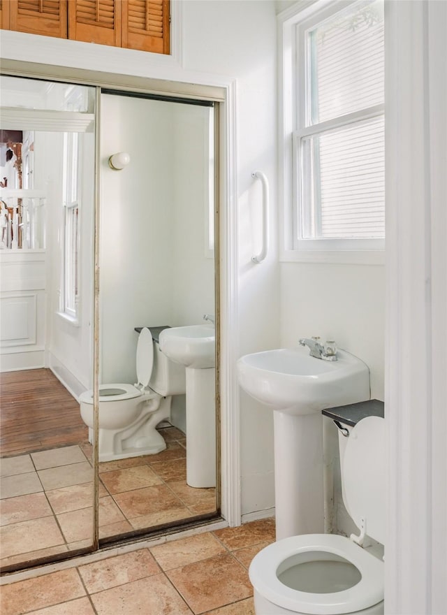 bathroom featuring toilet and tile patterned flooring