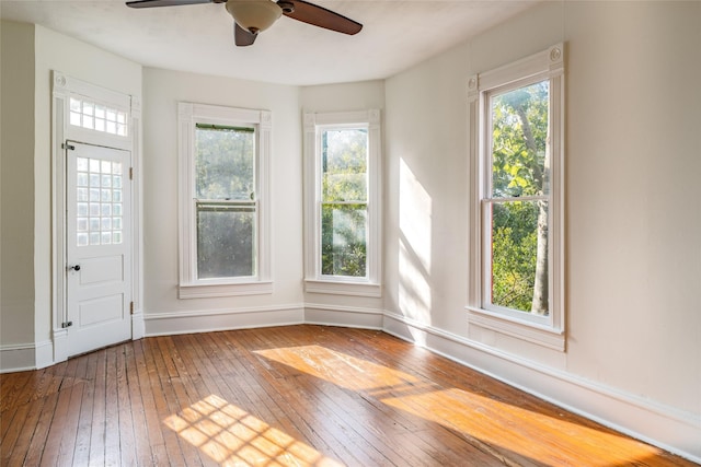 empty room with wood-type flooring and ceiling fan