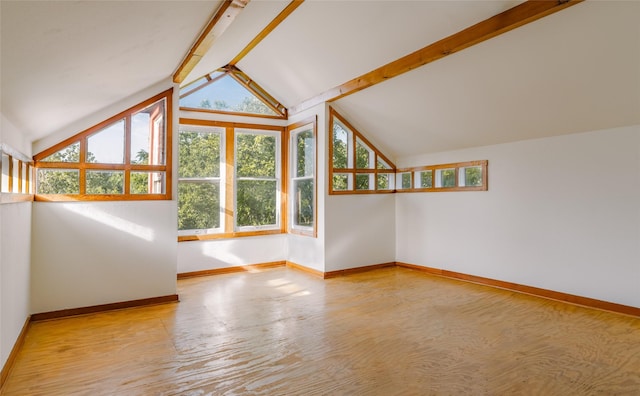 unfurnished living room with lofted ceiling with beams