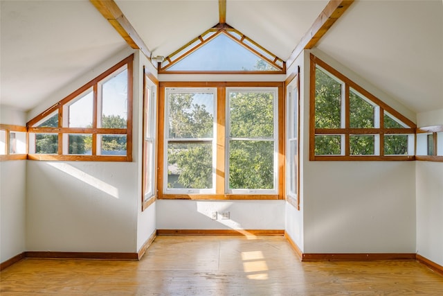 bonus room featuring lofted ceiling with beams and light wood-type flooring