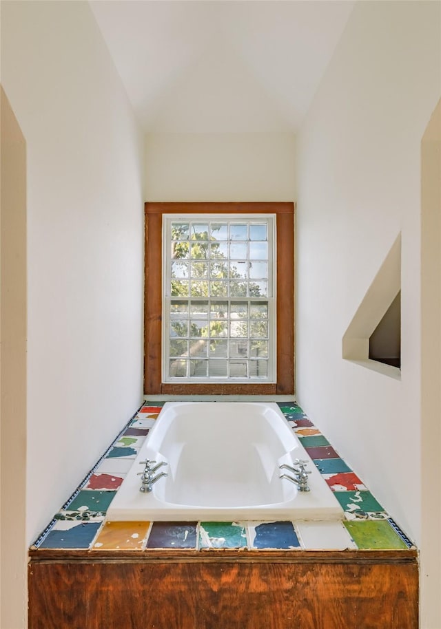 bathroom featuring tiled tub