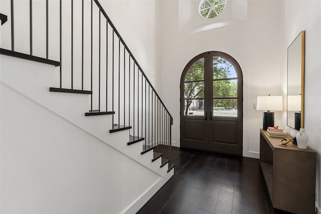 foyer featuring a high ceiling, french doors, and dark wood-type flooring