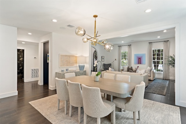 dining room featuring dark hardwood / wood-style flooring and a chandelier