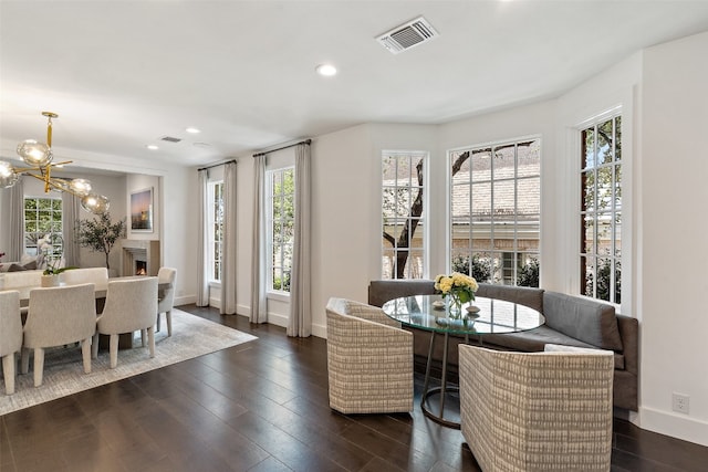 dining space with dark wood-type flooring and a chandelier