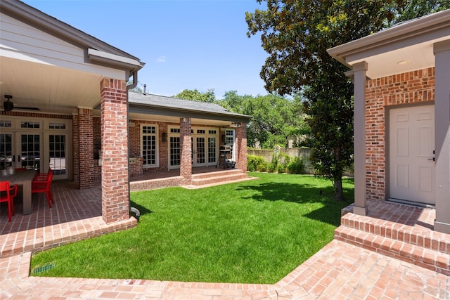 view of yard with a patio area and french doors