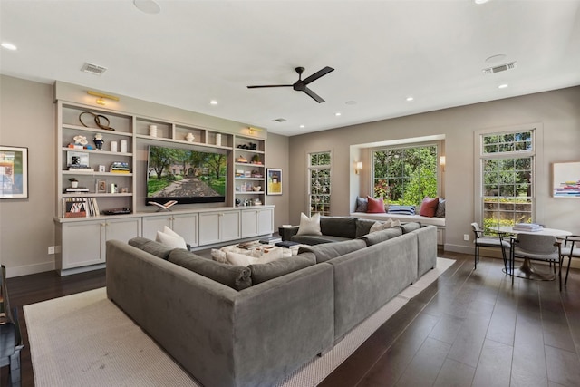 living room featuring dark hardwood / wood-style flooring and ceiling fan