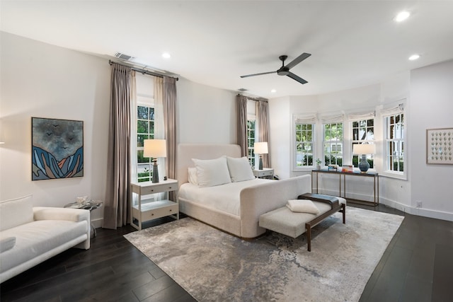 bedroom with dark hardwood / wood-style flooring, multiple windows, and ceiling fan