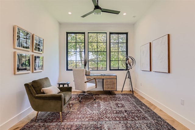 living area with ceiling fan and hardwood / wood-style flooring