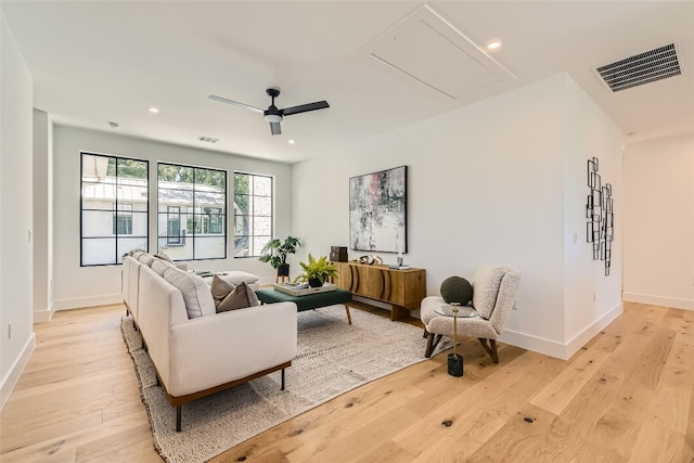 living room featuring ceiling fan and light wood-type flooring