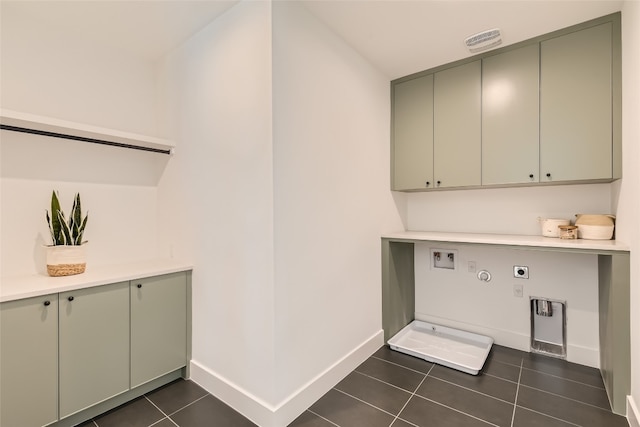 clothes washing area with hookup for a washing machine, cabinets, dark tile patterned floors, and electric dryer hookup