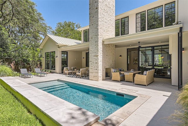 view of swimming pool featuring an outdoor hangout area, a patio area, and ceiling fan