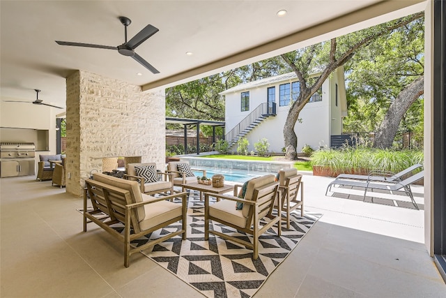 view of patio / terrace with exterior kitchen, outdoor lounge area, and ceiling fan