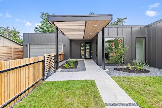 doorway to property featuring a lawn