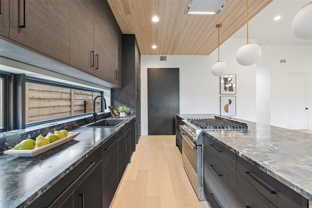 kitchen featuring wood ceiling, stainless steel stove, light wood-type flooring, a sink, and recessed lighting