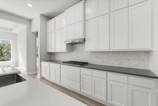 kitchen with white cabinetry, stainless steel gas cooktop, and light hardwood / wood-style flooring