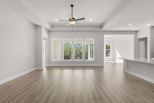 unfurnished living room with hardwood / wood-style flooring and ceiling fan