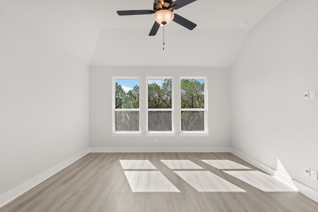 unfurnished room featuring ceiling fan, lofted ceiling, and light hardwood / wood-style flooring