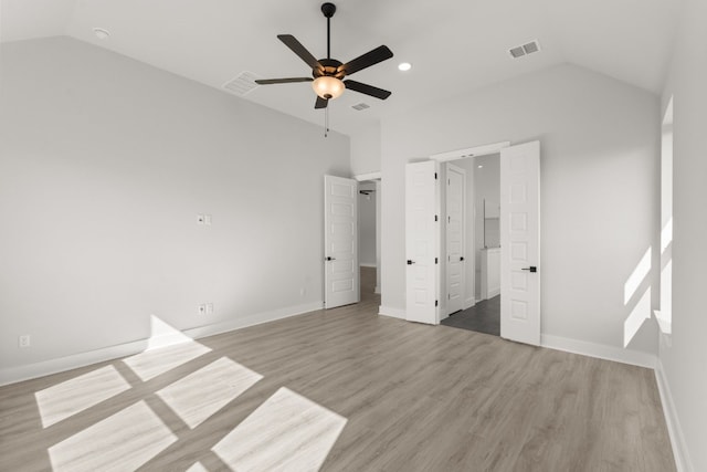 unfurnished bedroom featuring light hardwood / wood-style flooring, ceiling fan, and lofted ceiling